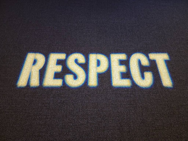 das Wort Respekt im Licht auf schwarzem Teppich oder Teppich - Foto, Bild