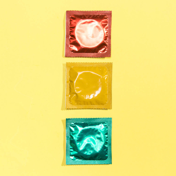 top view red yellow green condoms. High quality photo - Fotoğraf, Görsel