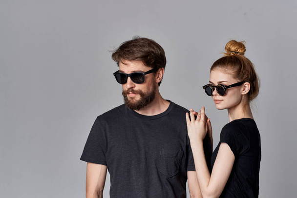 a young couple friendship communication romance wearing sunglasses light background - Photo, Image