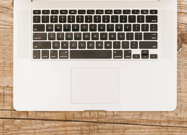 topview laptop keyboard wooden background. High quality photo - Фото, изображение