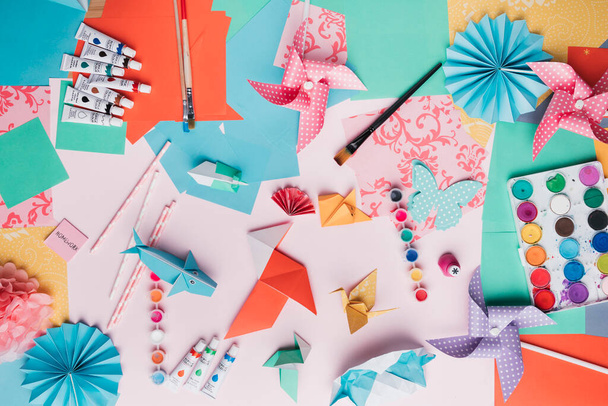 top view origami craft paint tube paintbrush straw colored paper. High quality photo - 写真・画像