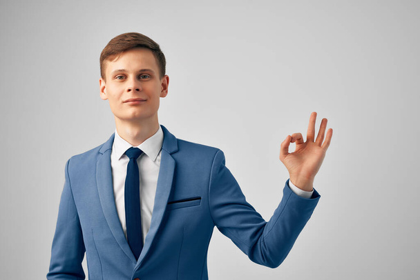 business man in a suit gesturing with his hands office professional work. High quality photo - Zdjęcie, obraz