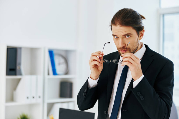 man in a suit in the office with documents technologies - Φωτογραφία, εικόνα