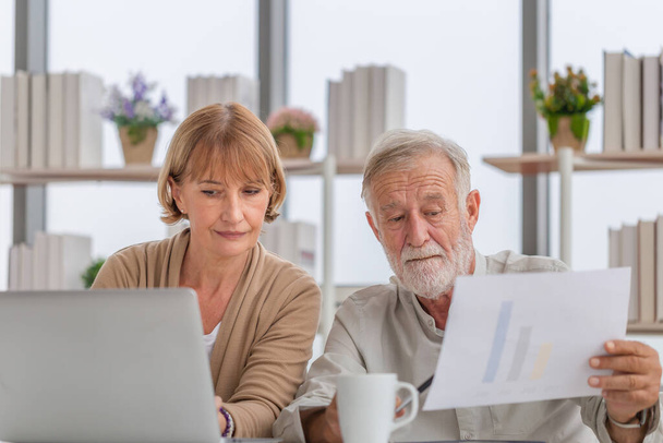 Besorgte Senioren prüfen ihre Rechnungen, pensionierte ältere Familienmitglieder lesen Dokumente - Foto, Bild