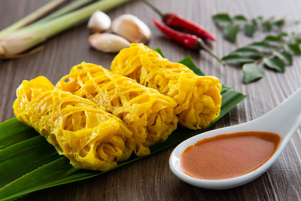 Roti Jala or lace pancake is Malaysian traditional food, a popular Malay snack served with curry dishes - Photo, Image