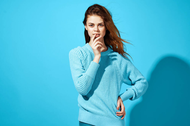 portrait of a woman in a blue sweater  posing in studio - Valokuva, kuva