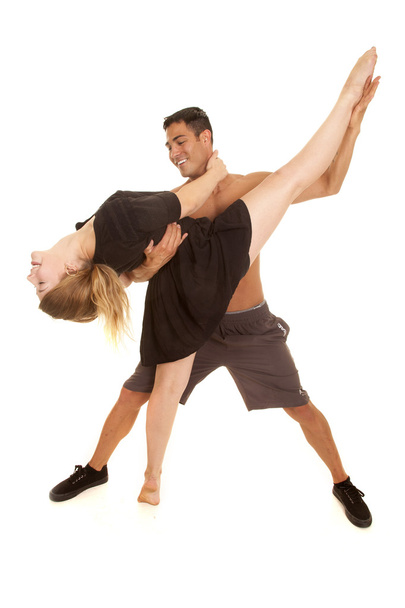 Fitness woman kick up leg by man in plank look down - 写真・画像