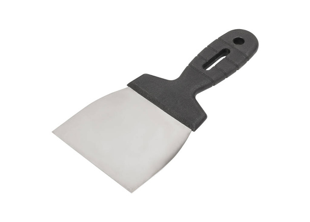 Construction spatula with dark handle isolated on white background. Construction tool, construction tool, putty spatula, Putty knife, sealant spatula. - Photo, Image