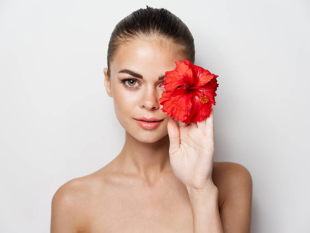 woman with red flower in hand. High quality photo - Photo, image