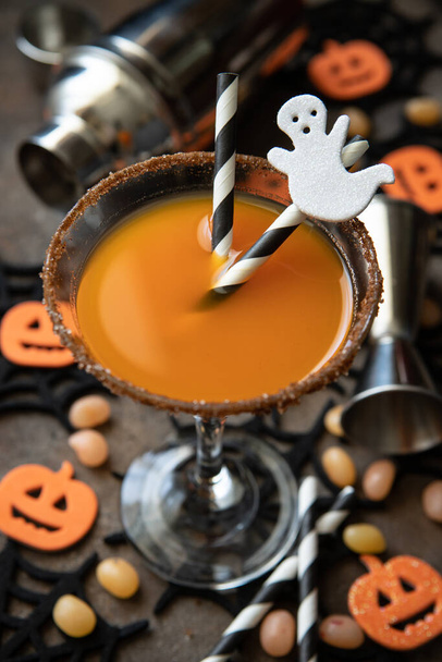 Autumn pumpkin cocktail with Halloween decor on  dark  background, selective focus with shallow depth of field - Фото, зображення