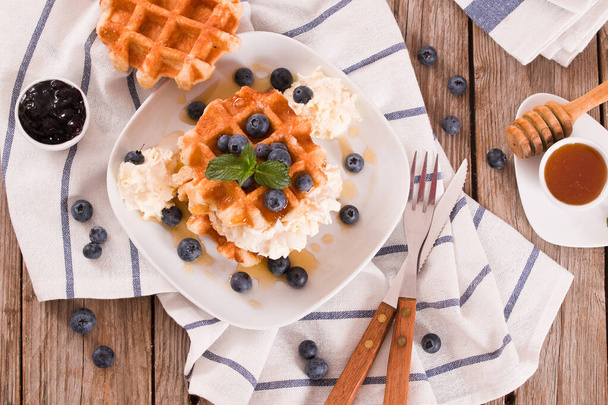 Waffles with blueberries and whipped cream. - Photo, Image