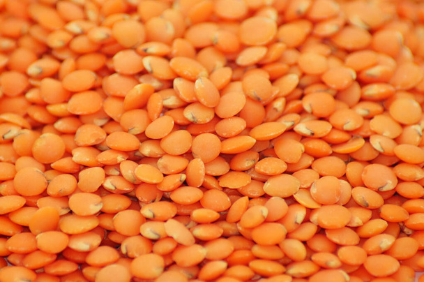 The close-up shot of tiny orange lentil isolated on a white background - Photo, image