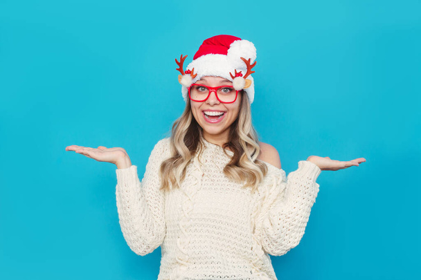 joyful woman posing in santa hat and funny eyeglasses - Fotó, kép