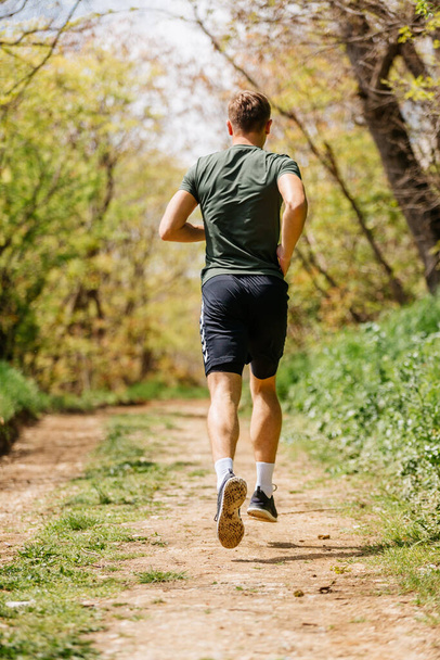 Sport man running. Portrait of runner man jogging in park. Sport workout outdoor. Athlete training run exercise - Фото, изображение