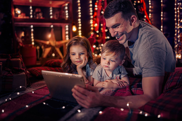 family watching funny video on digital tablet. family, Christmas, x-mas, technology and people concept - Photo, Image