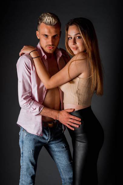 Body shot of a stylish fashion couple wearing modern style clothes - 写真・画像