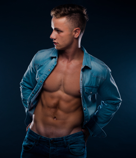 Handsome man or young, caucasian, unshaven macho, fashion model, posing isolated on dark wall - Φωτογραφία, εικόνα