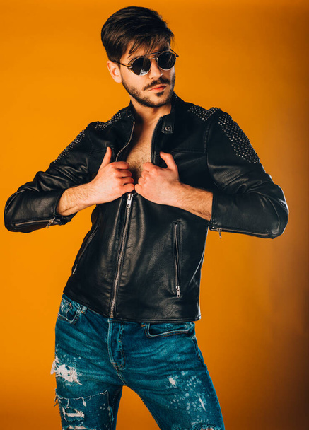 Body shot of a fashion male model posing dressed in jacket and jeans - Photo, image