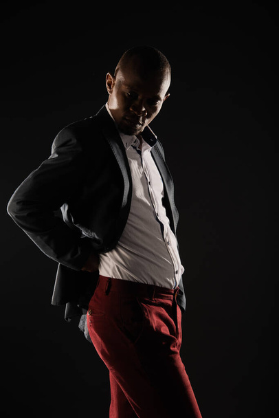 African black male is posing while fixing his formal suit - 写真・画像