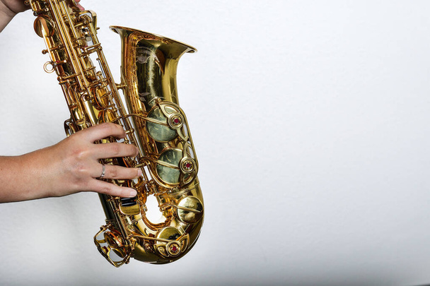 Hands of a saxophonist on a white background - Photo, image