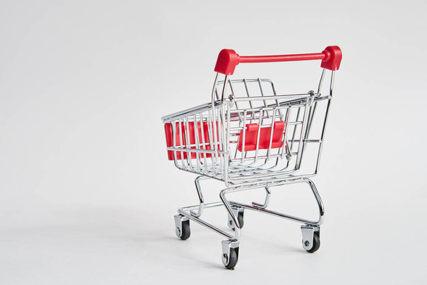 empty trolley on light background shopping supermarket service - Фото, изображение