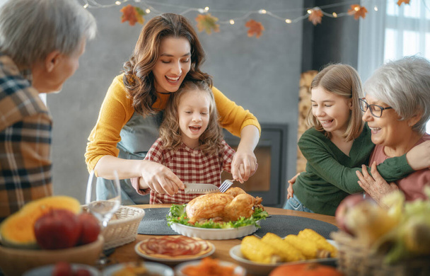 Thanksgiving Day, Autumn feast. Happy family sitting at the table and celebrating holiday. Grandparents, mother and children. Traditional dinner. - Foto, imagen