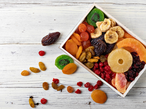 Dried fruits collection on a wooden background. - Photo, Image