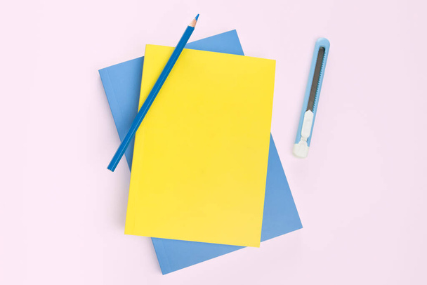 flat lay book and stationery on pink background - Foto, afbeelding