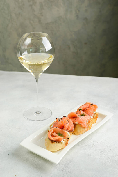 bruschetta with salmon in the restaurant. High quality photo - Foto, imagen