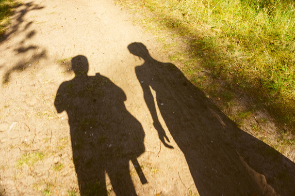 The shadow of two people on the ground - Zdjęcie, obraz