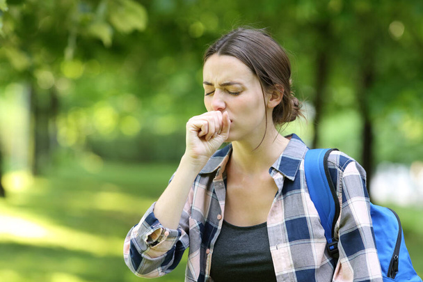 Ill student coughing walking in a campus - Foto, Bild