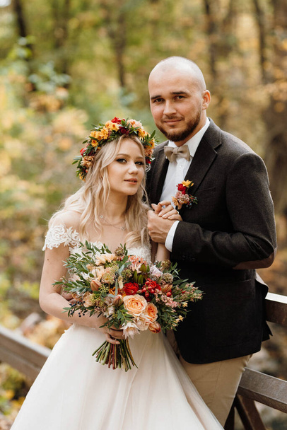 walk of the bride and groom through the autumn forest in October - Photo, Image