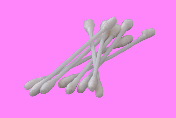 Pile of several white cotton buds with plastic material in isolation on a pink background, the concept of health, beauty, and hygiene - Photo, Image
