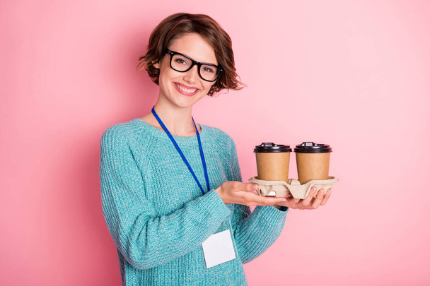 Photo of nice optimistic curly brunette hairdo lady hold coffee wear spectacles blue sweater isolated on pink color background - Foto, imagen