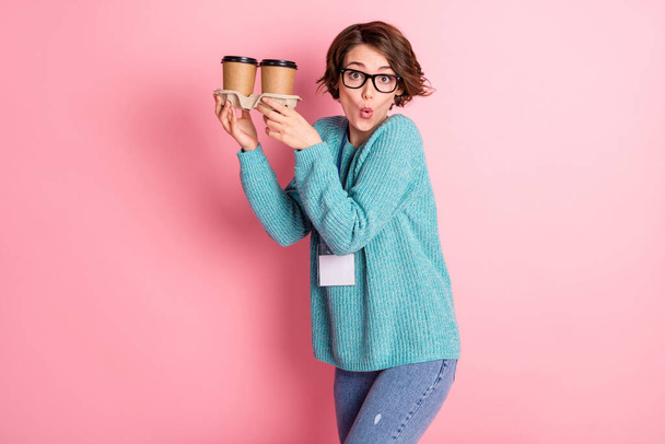 Photo of brunette bob haired girl hold paper coffee cup wear glasses name tag press isolated on pink color background - 写真・画像