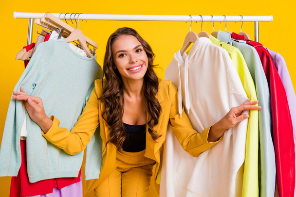 Photo of pretty attractive young woman dressed suit blazer smiling buying new clothes isolated yellow color background - 写真・画像