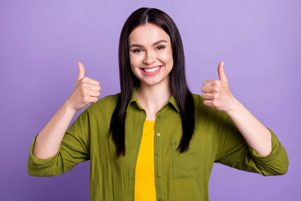 Photo of sweet shiny young woman wear khaki outfit smiling rising thumbs up isolated violet color background - Fotoğraf, Görsel