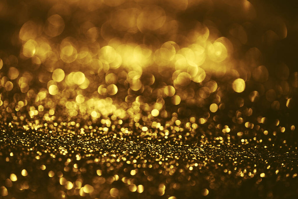 Golden glitter bokeh lighting texture Blurred abstract background for birthday, anniversary, wedding, new year eve or Christmas - Photo, image