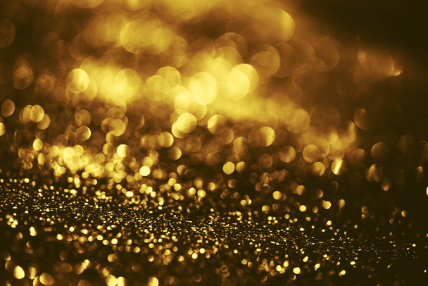 Golden glitter bokeh lighting texture Blurred abstract background for birthday, anniversary, wedding, new year eve or Christmas - Foto, afbeelding