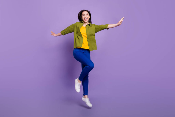 Full length photo of young cheerful girl happy positive smile carefree jump isolated over violet color background - Fotografie, Obrázek