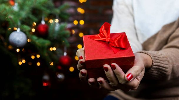 Woman holding gift box in hands. Christmas, New Year, birthday concept - Foto, immagini