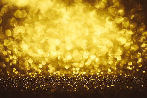 Golden glitter bokeh lighting texture Blurred abstract background for birthday, anniversary, wedding, new year eve or Christmas - Фото, изображение