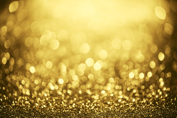 Golden glitter bokeh lighting texture Blurred abstract background for birthday, anniversary, wedding, new year eve or Christmas - 写真・画像