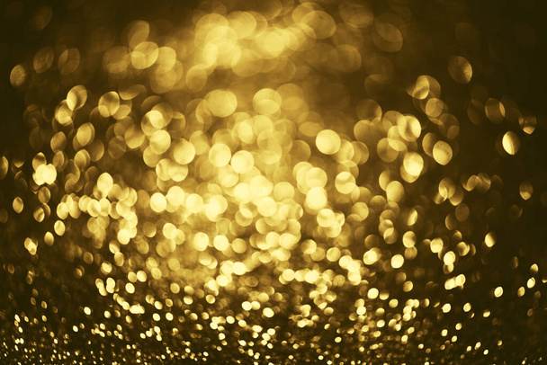 Golden glitter bokeh lighting texture Blurred abstract background for birthday, anniversary, wedding, new year eve or Christmas - Foto, immagini