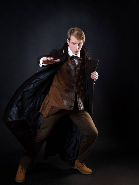character of the steampunk story, a young attractive man in an elegant long coat - Fotoğraf, Görsel