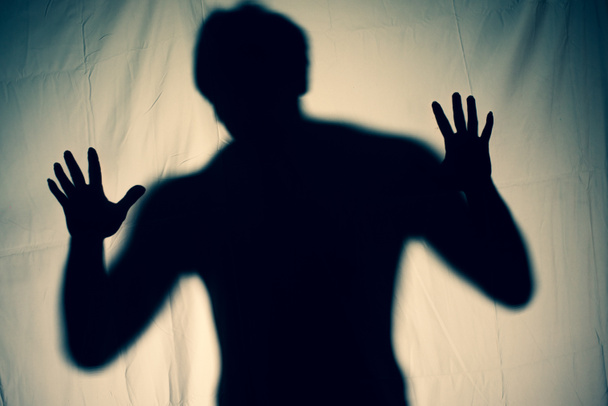 frightening ghost in a white sheet nightmare. scary picture of hands behind curtain. halloween idea - Photo, Image