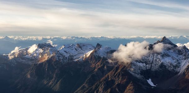 Aerial View of Canadian Rocky Mountains with snow on top - 写真・画像