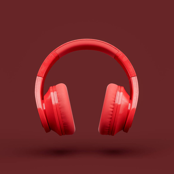 Monocromo solo color rojo sobre los auriculares de la oreja en un estudio rojo, vista frontal, representación 3d - Foto, Imagen