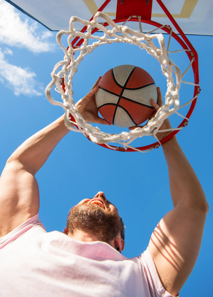 guy has sport motivation. sport and hobby. dunk in basket. slam dunk in motion. - Photo, Image