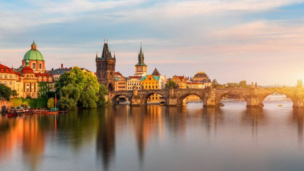 Charles Bridge in Prague in Czechia. Prague, Czech Republic. Charles Bridge (Karluv Most) and Old Town Tower. Vltava River and Charles Bridge. Concept of world travel, sightseeing and tourism. - Photo, Image